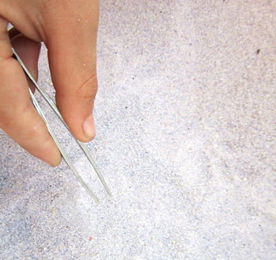 Tweezers and sand